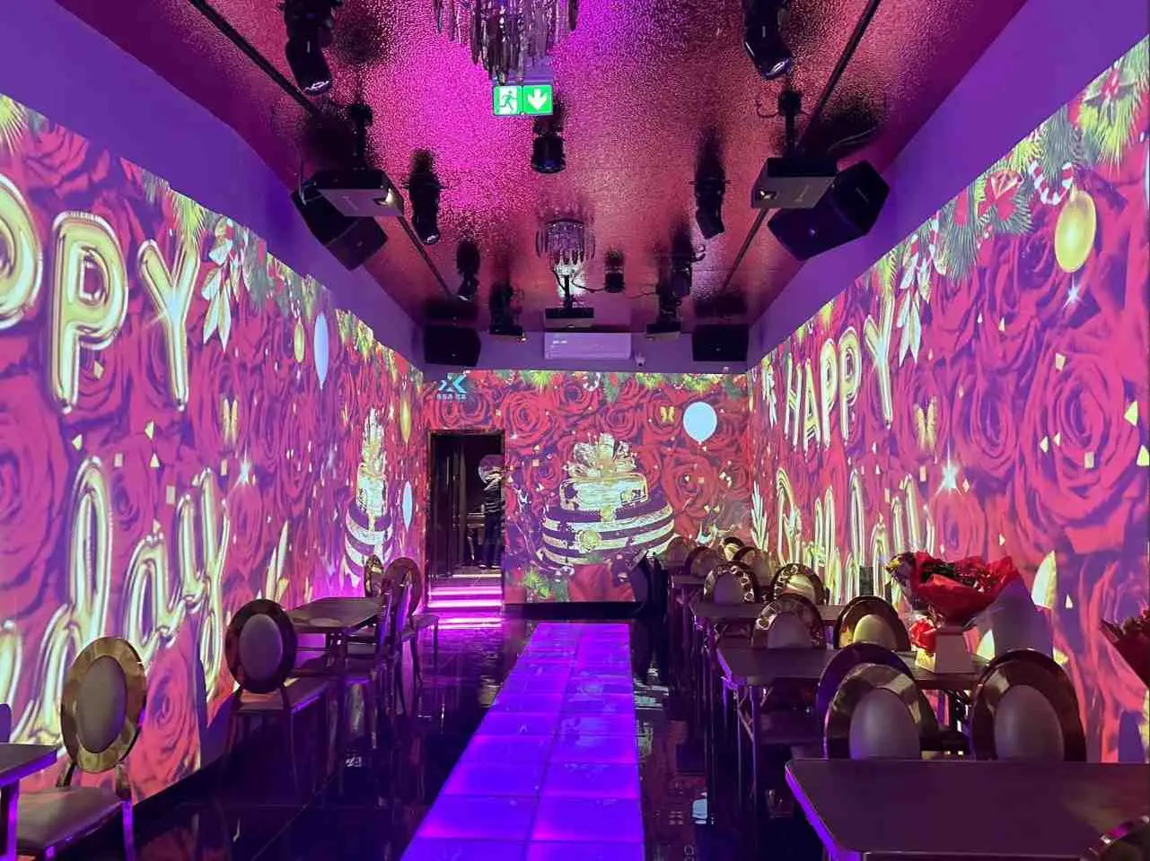 Roses and Happy Birthday message showing on wall in holographic function room